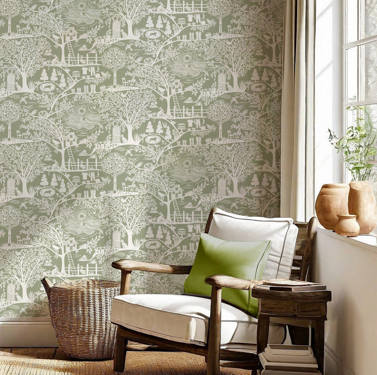Homegrown Green wallpaper by Belgravia, a soft green print behind a low chair and potted plants