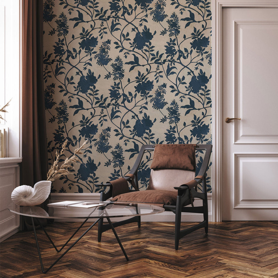 Tangleby Navy wallpaper by Josephine Munsey, a dense navy floral trail on warm taupe in a room with a herringbone floor and a pink panelled door