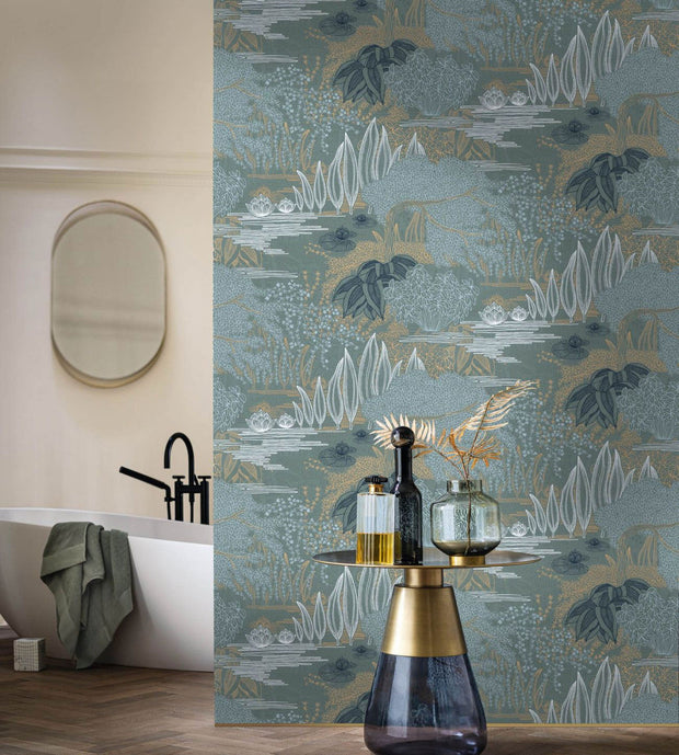Jasmin wallpaper by Casamance, gold cranes and blossom on teal beside a freestanding bath and a brass side table