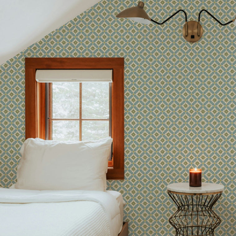 Nova and Sol wallpaper by Josephine Munsey, a small hand painted celestial print papered across the sloping walls of an attic bedroom