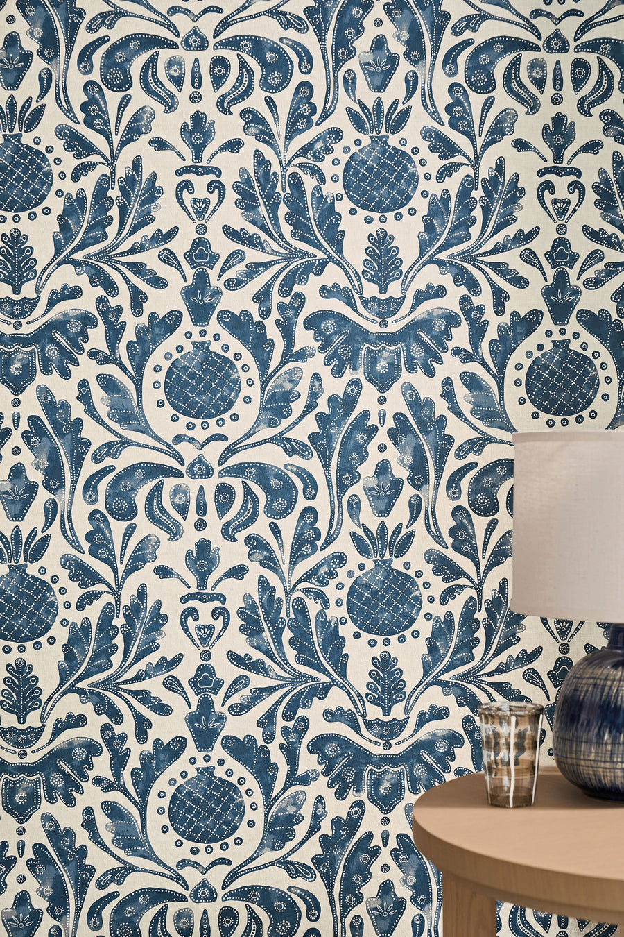 Castellane Indigo wallpaper by Nina Campbell, a blue pomegranate medallion damask in a panelled room