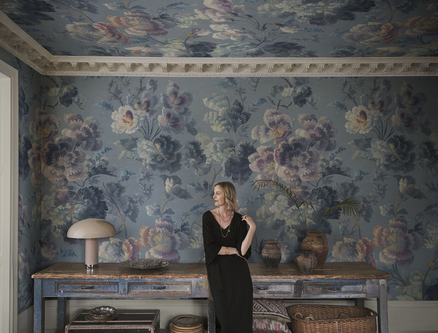 Ines Blue mural by Sandberg, enormous painted blooms carried over the walls and right across the ceiling of a room, with a figure standing against them for scale