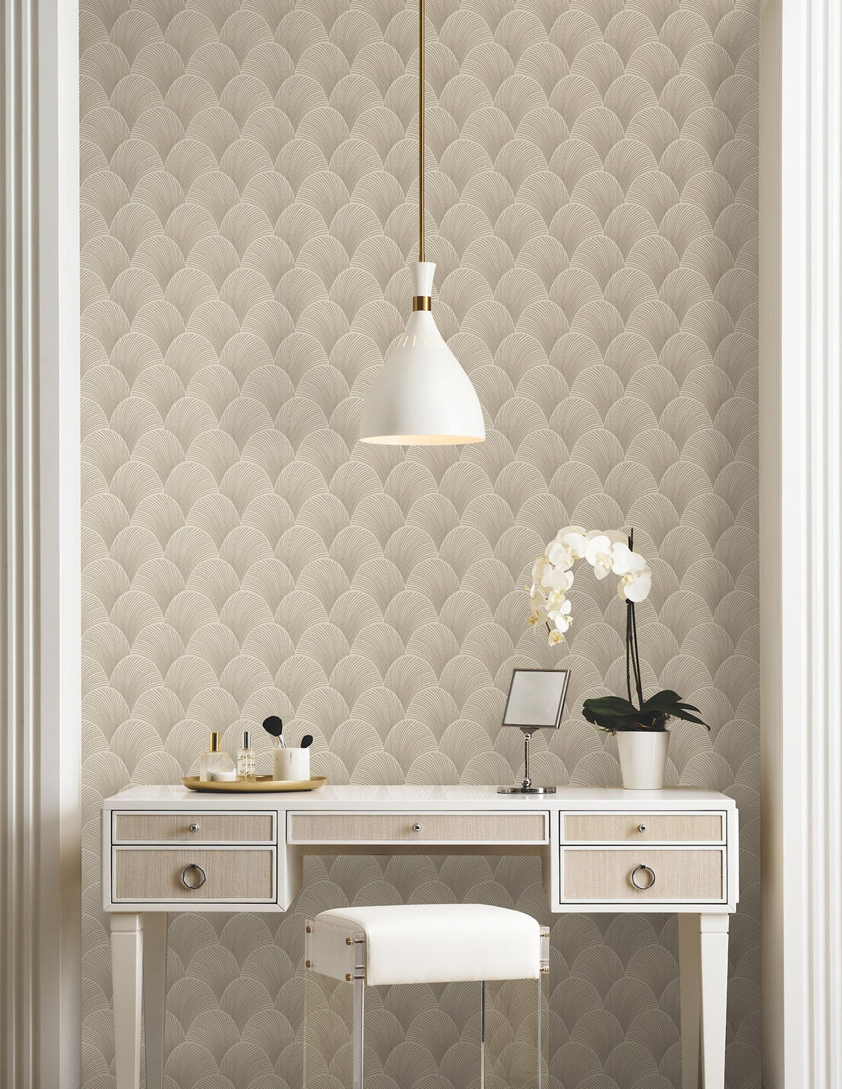 Candice Olson Metallic Scallop Beige wallpaper by York Wallcoverings, a large quilted metallic scallop behind a white dressing table and an orchid