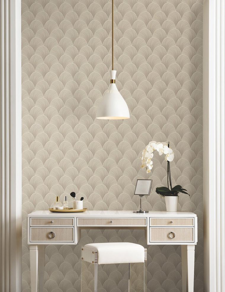 Candice Olson Metallic Scallop Beige wallpaper by York Wallcoverings, a large quilted metallic scallop behind a white dressing table and an orchid