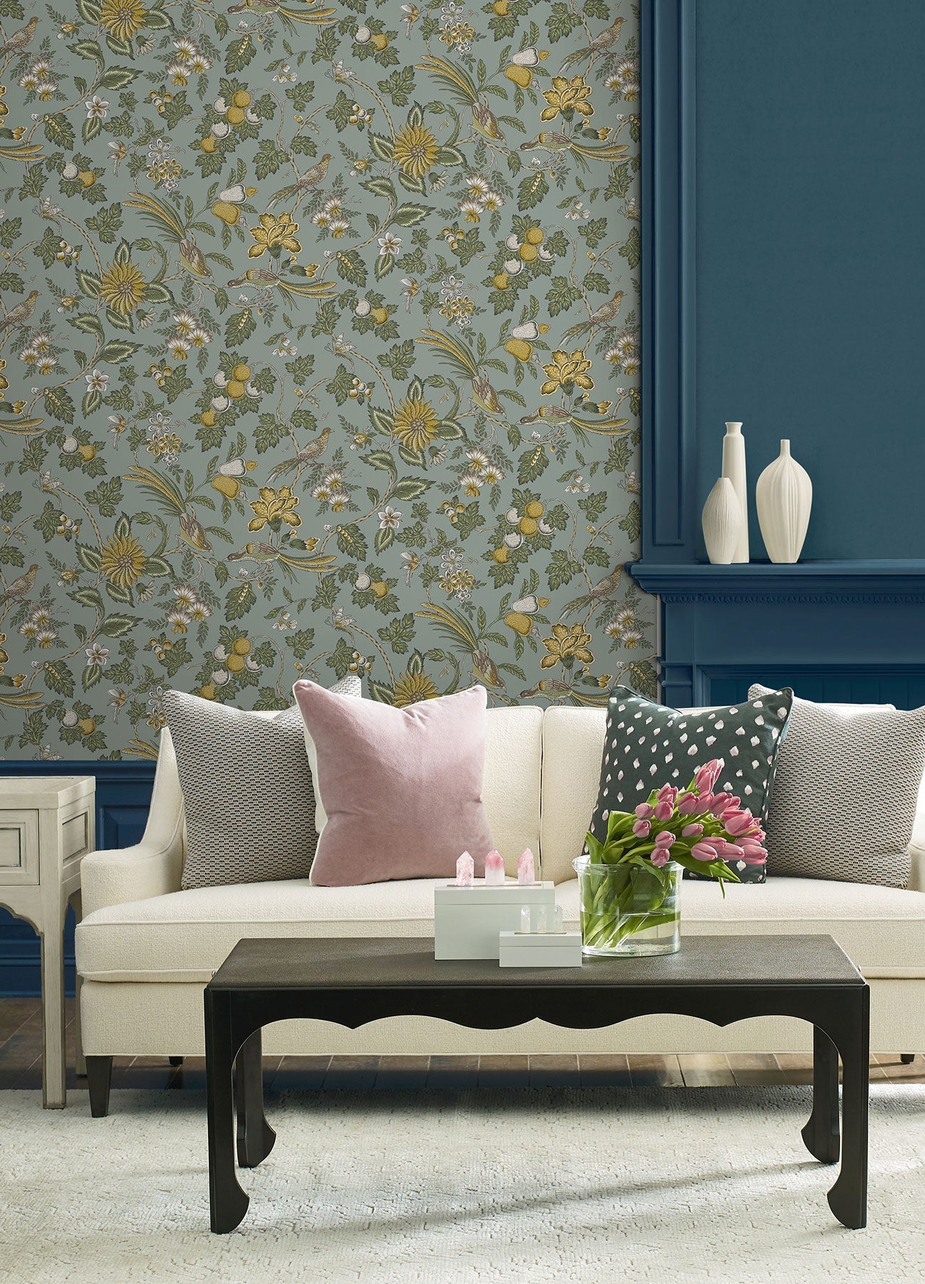 Parterre Jacobean Light Blue wallpaper by York Wallcoverings, a blue grey Jacobean trail with mustard blooms above a teal panelled fireplace