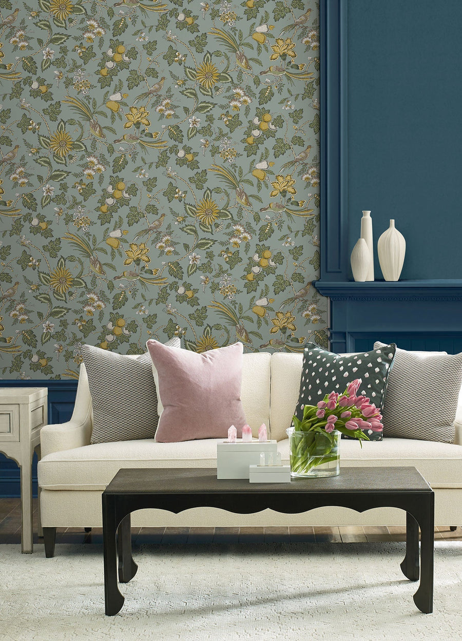 Parterre Jacobean Light Blue wallpaper by York Wallcoverings, a blue grey Jacobean trail with mustard blooms above a teal panelled fireplace